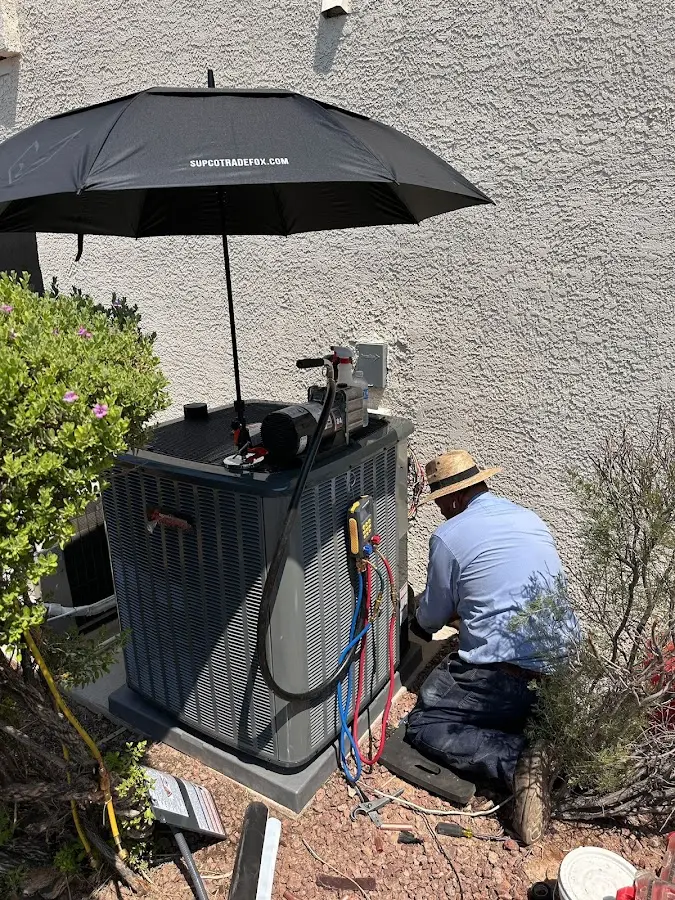 HVAC technician performing outdoor AC maintenance in Upper Darby
